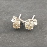 A pair of diamond ear studs, the claw set stones approx 0.6ct mounted in 18ct white gold1.1g