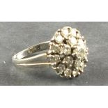 A diamond cluster ring, the central stone within two graduated bands, on an 18ct white gold band,