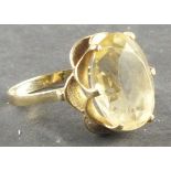 A citrine dress ring, circa 1960's, the oval faceted stone with a fancy setting and 9ct gold band,