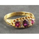 A ruby and diamond dress ring, the arrangement of stones claw set in an 18ct gold band, 3.6g