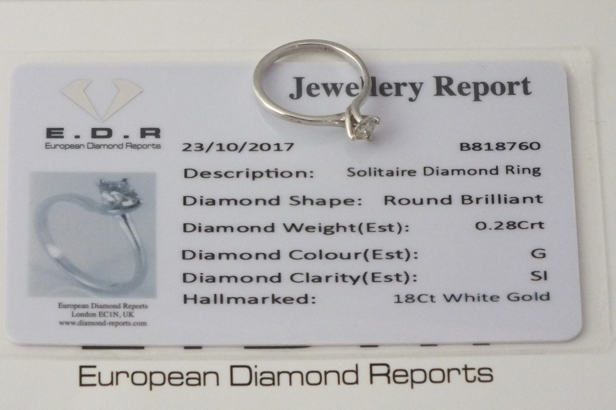 A solitaire diamond ring, claw set in an 18ct white gold band, 1.9g, together with a European - Image 2 of 2