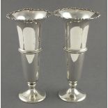 A pair of silver vases Birmingham 1923, of trumpet form and embossed scalloped rims, 8" high (