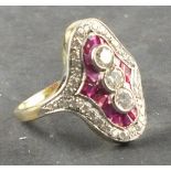 An Art Deco ruby and diamond dress ring, with an arrangement of three stones on a ruby ground within