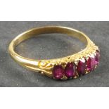 A five stone ruby dress ring, with a pierced fancy setting and 18ct gold band, 3.2g