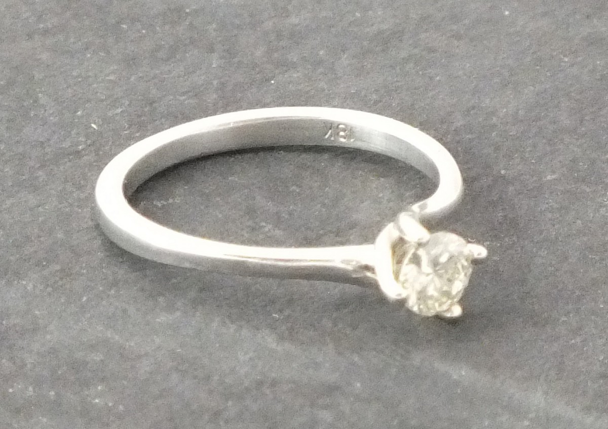 A solitaire diamond ring, claw set in an 18ct white gold band, 1.9g, together with a European