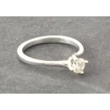 A solitaire diamond ring, claw set in an 18ct white gold band, 1.9g, together with a European