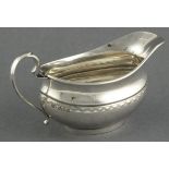 A silver boat shaped cream jug, E. Viner, Sheffield 1959, of bellied form with a bright cut banding,