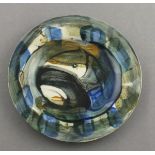 Reginald James LLOYD (British b. 1926) ceramic plate decorated in blue, green & brown glazes on a