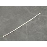 A diamond line bracelet, the round cut stones claw set in 18ct white gold, 11.9g