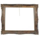 A mid 20th Century composition swept picture frame, of a gilt bronze finish with foliate mid