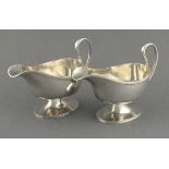 A pair of silver sauceboats William Hutton & Sons, Sheffield 1926, with reeded rims and pedestal
