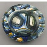 Reginald James LLOYD (British b.1926) ceramic plate, decorated in blue, orange, green & black glazes