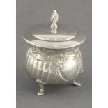 A silver tea caddy William Devenport, Birmingham 1903, of lidded cauldron form raised on three pad