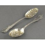 A pair of silver berry spoons, Henry Wigfull, Sheffield 1894, with fancy terminals and embossed