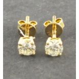 A pair of diamond ear studs, claw set with screw backs in 18ct yellow gold 1.2g