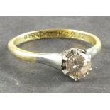 A solitaire diamond ring, the claw set stone in an 18ct gold and platinum band, 2.6g