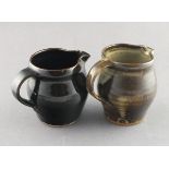 Leach Pottery, Two pottery jugs with tenmoku glaze, Impressed Leach Pottery mark to base (on