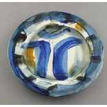 Reginald James LLOYD (British b. 1926) ceramic plate decorated in blue, black & orange glazes on a