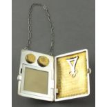 An Edwardian white metal necessaire, stamped "Sterling", rectangular with a loop suspension chain,