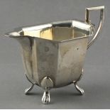 A vintage silver cream jug, Sheffield 1959 - Eric Viner, of faceted from and raised on four pad