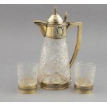A late 19th Century French cut glass and silver gilt mounted tete-a-tete, the decanter with square