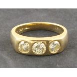 A three stone diamond ring, gypsy set in 18ct yellow gold, 1.61ct total, 9.5g. Illustrated