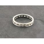 A diamond eternity ring, set in a platinum band, 3.1g