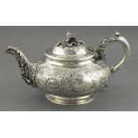 An early Victorian silver teapot, London 1839, Charles Gordon, with floral repousse decoration,