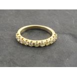 A half hoop diamond eternity ring, the uniform stones total 0.75 ct set in an 18ct yellow gold band,