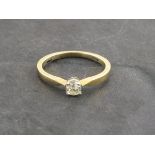 A solitaire diamond ring, the circular cut stone claw set within a 9ct yellow gold band, 2g