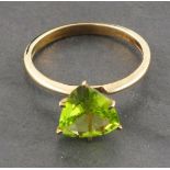 A 9ct gold and peridot ring, the trillion cut stone within a claw setting, size N
