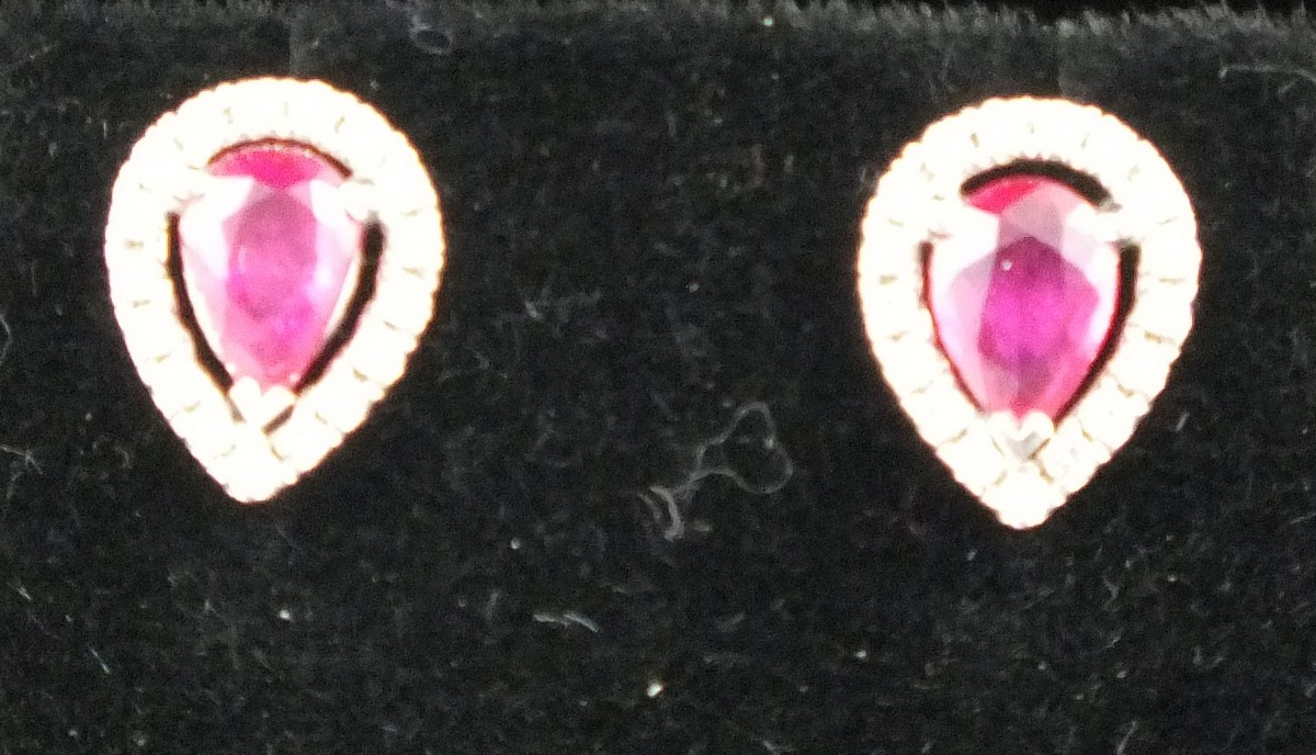 A pair of ruby and diamond ear studs,  the drop shaped central stones, total wight 1.19ct, within