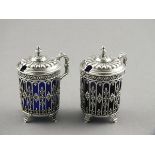 A pair of French silver mustards, circa 1900, of a delicate pierced foliate design with fluted domed