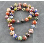 A vintage Murano glass bead necklace, the uniform strand of opaque and clear coloured glass with