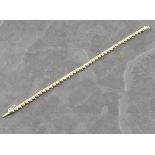 A diamond line bracelet, the round cut stones set in 14ct links, 10g