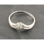 An 18ct white gold ring featuring six diamonds set around a central stone and double shank