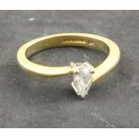 A solitaire diamond ring, the pear shaped stone approx. 0.4 ct set in an 18ct yellow gold band, 2.9g