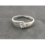 A silver dress ring stamped 925 set with central solitaire white stone, Size O