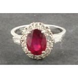 A ruby and diamond ruby and diamond ring,  the treated ruby 2.42ct within a band of diamonds set