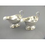 A pair of silver sauce boats, Sheffield 1926, William Hutton, of oval form with a beeded rim and