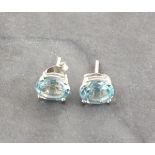 A pair of aquamarine ear studs, the oval cut stones claw set on silver studs
