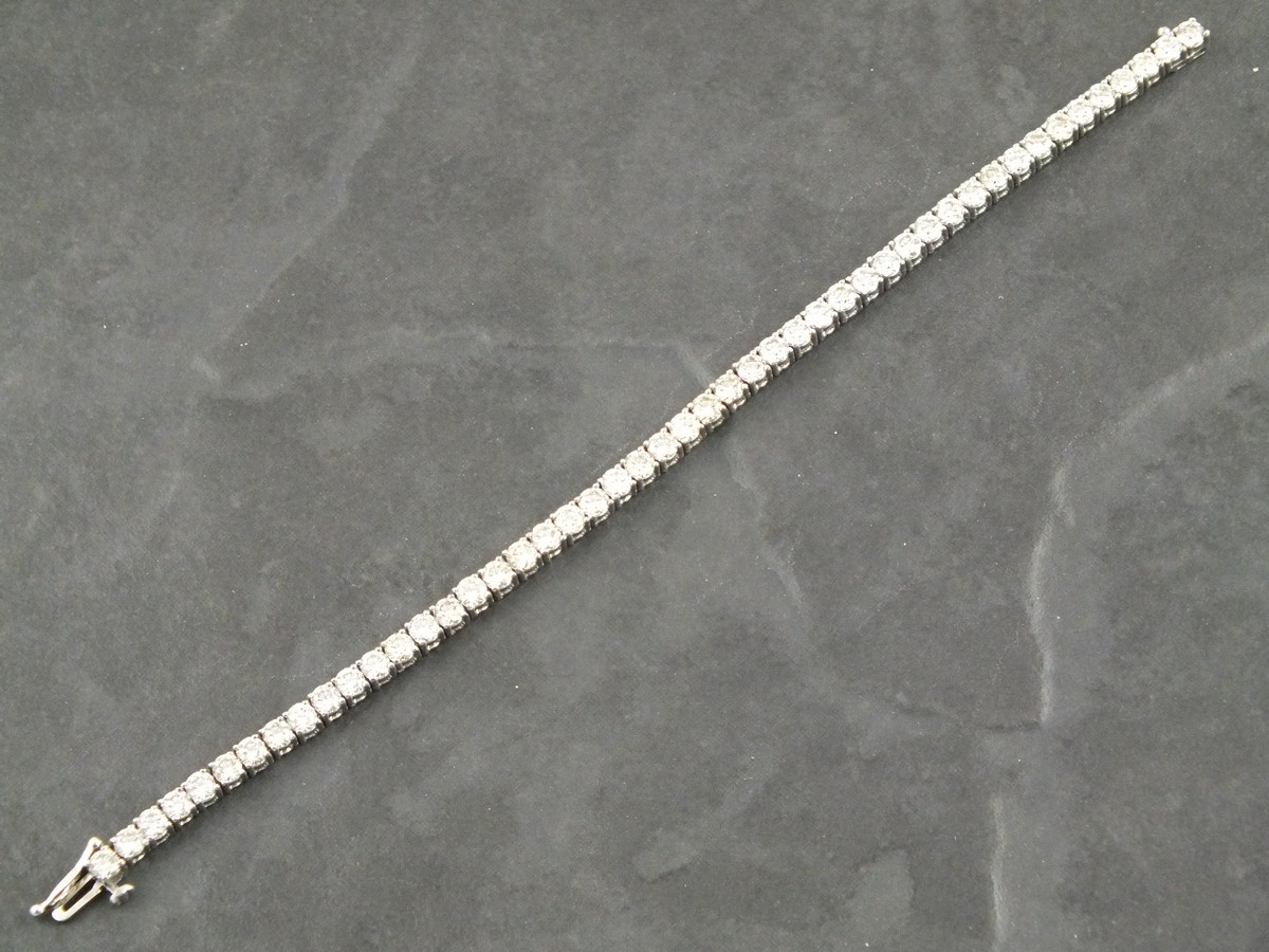 A diamond line bracelet, the uniform round brilliant cut diamonds set in a 14ct white gold