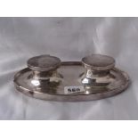 Double ink stand of oval outline 8” wide
