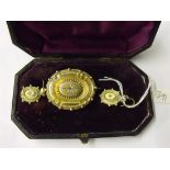 A Boxed Victorian diamond set oval brooch and matching ear pendants