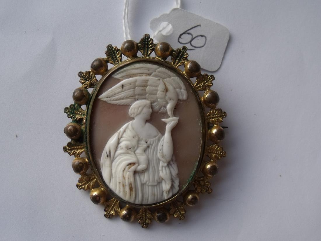 Gilt metal framed shell cameo brooch of lady feeding eagle 2" long