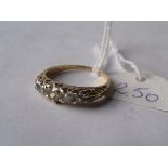 An antique 5 stone diamond ring in 18ct gold with carved shoulders, size N