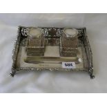 GOOD INKSTAND rectangular outline with galleried sides, enclosing two glass wells, over claw feet