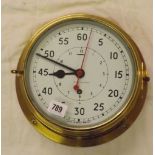 A brass bulkhead clock