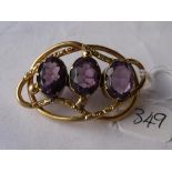 A large antique gold brooch set with three substantial amethyst stones 11.8g inc