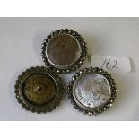 An unusual antique set of three cut steel mop buttons carved with flowers and marked A.P. Cie Paris